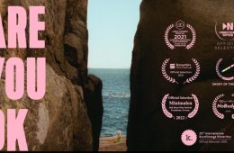 Are You OK - award winning erotic short film, a woman by the sea as seen between a chasm